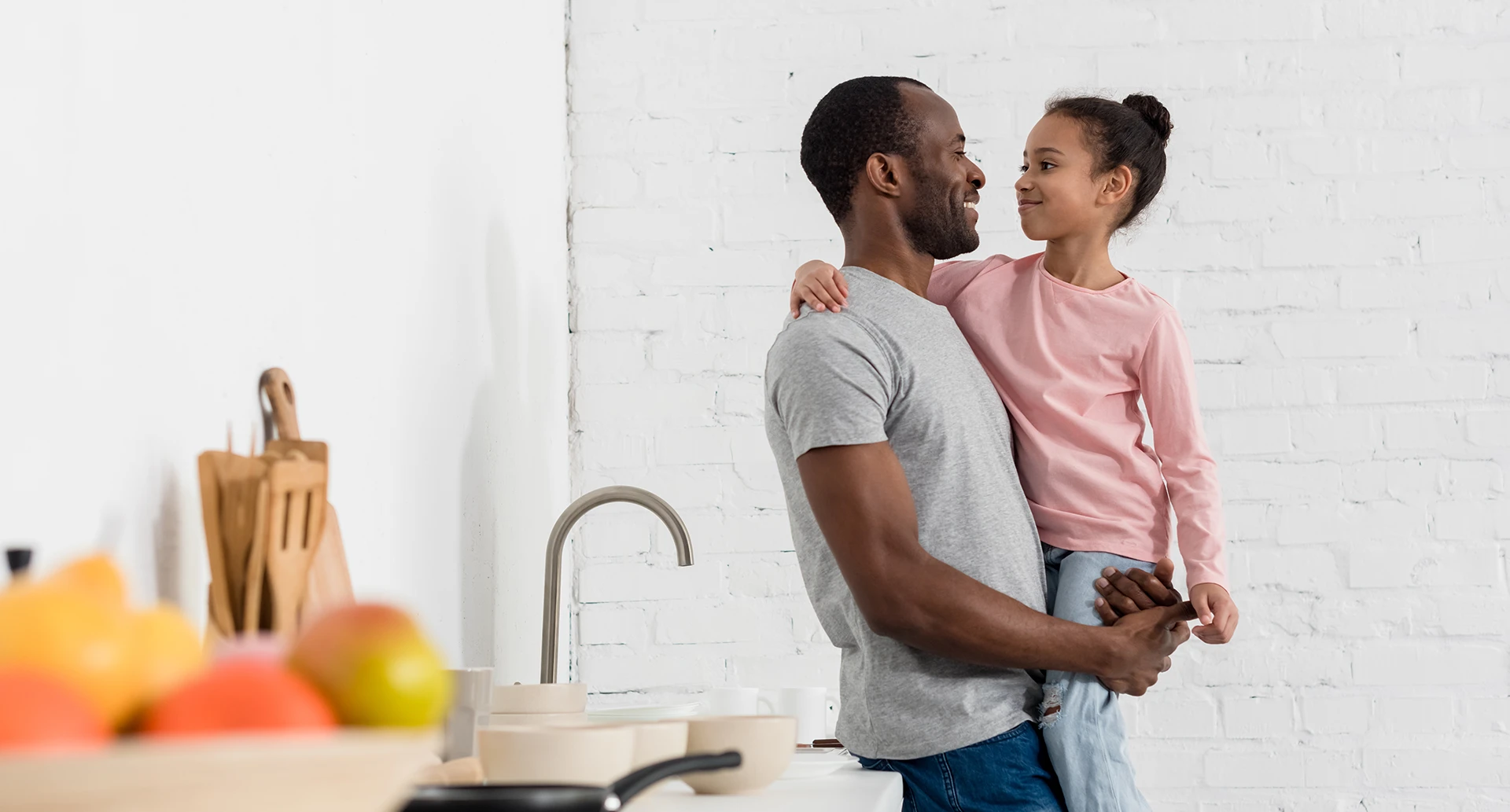 father and daughter smiling and hugging