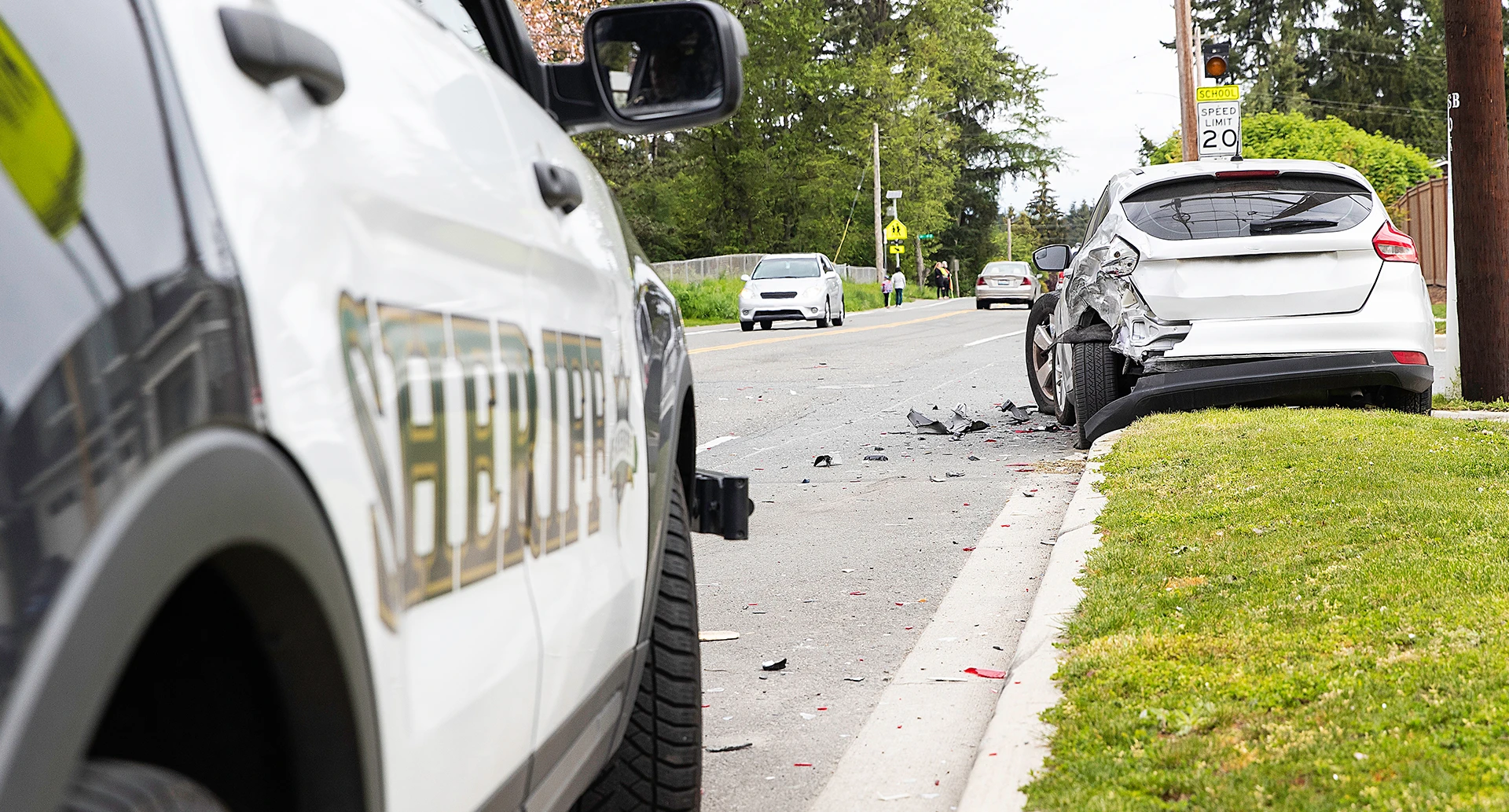 police vehicle parked behind a rear end car crash