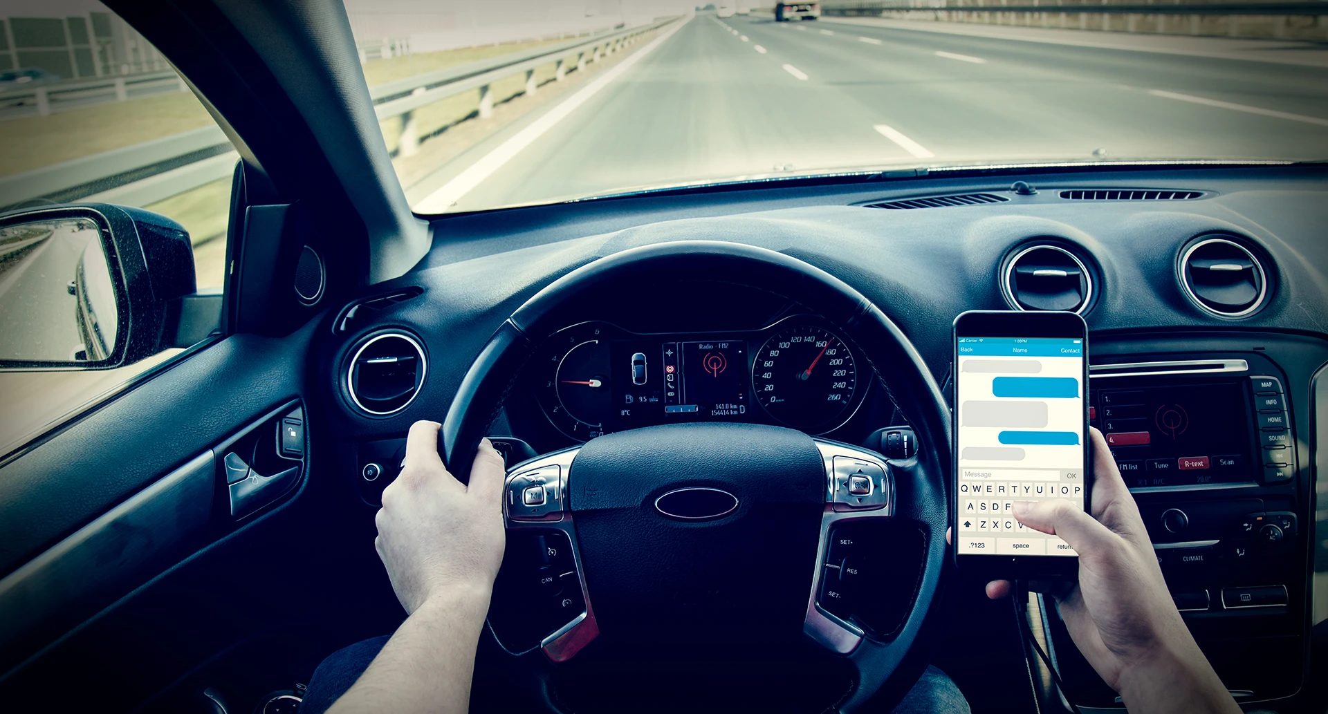 person holding their phone texting while driving at high speeds
